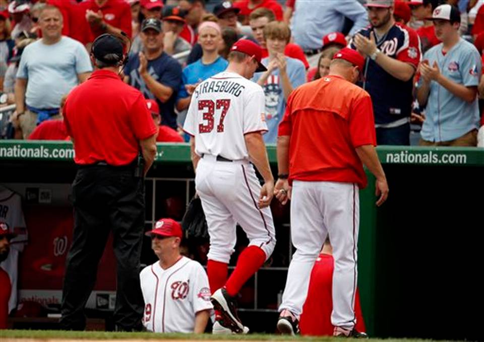 Washington Nationals starting pitcher Stephen Strasburg walks with pitching coach Steve McCatty right to the clubhouse after he was relieved during the fourth inning of a baseball game against the San Francisco Giants at Nationals Park Saturday J