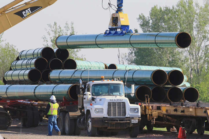 Pipes for the proposed Dakota Access oil pipeline that would stretch from the Bakken oil fields in North Dakota to Patoka Ill. are unloaded from rail cars Saturday