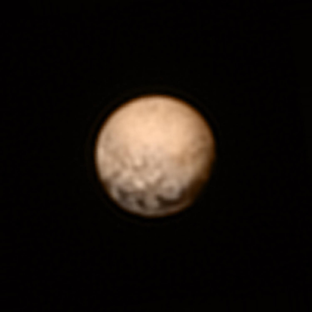 NASA released this image of Pluto on Monday. Pluto's equator where mysterious evenly-spaced dark terrain appears is seen near the bottom of the dwarf planet's disk. New Horizons LORRI telescopic camera took this image July 3 and scientists added color