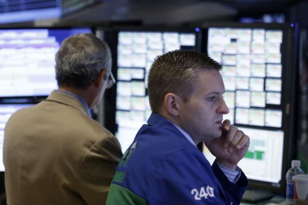 Traders work on the floor at the New