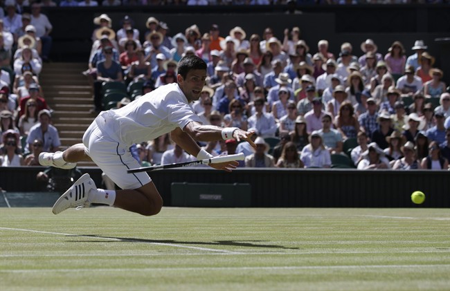 Novak Djokovic of Serbia drops his racquet after making a return to Richard Gasquet of France during their men's singles semifinal match at the All England Lawn Tennis Championships in Wimbledon London Friday