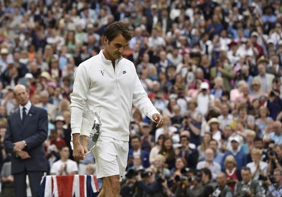 Switzerland holds his runner up trophy after being defeated by Novak Djokovic of Serbia in the men's singles final at the All England Lawn Tennis Championships in Wimbledon London Sunday