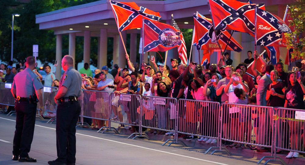 People wave Confederate flags outside the hotel that President Barack Obama is staying the night on Wednesday