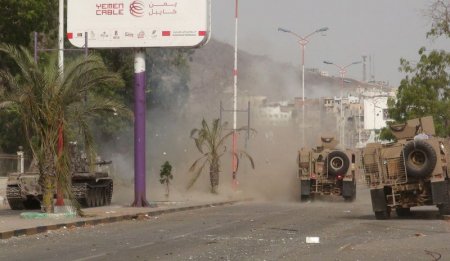 Military vehicles of the Southern Resistance fighters move during clashes with Houthi fighters on a street in Yemen's southern port city of Aden