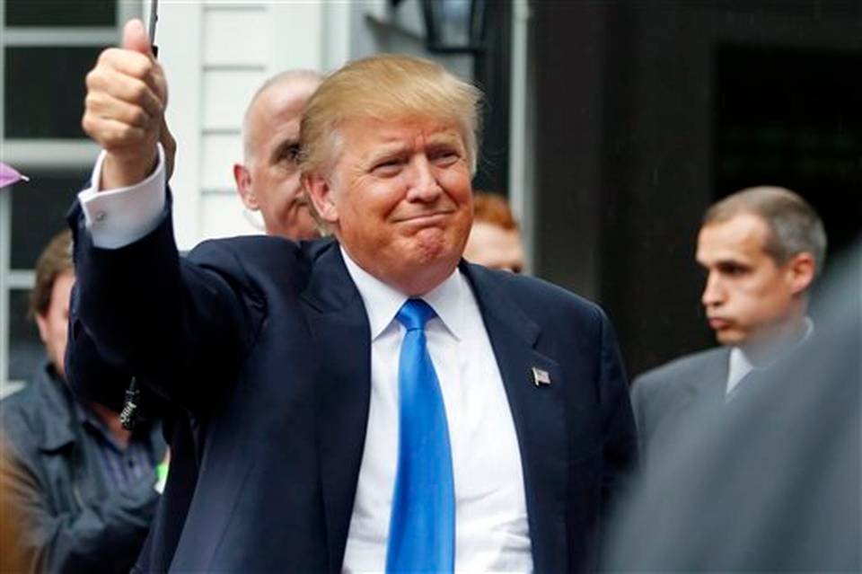 Republican presidential candidate Donald Trump waves as he arrives at a house party in Bedford N.H. Leading Republican donors have begun to call for calm as Republican-on Republican criticism intensifies in the G