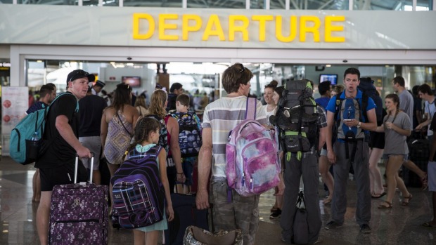 Passengers wait for news on flights out of Bali at Denpasar Airport