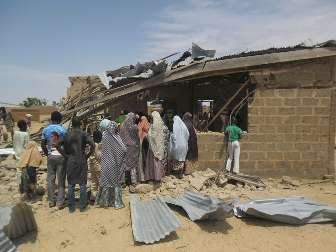 People gather at the site of suicide bomb attack at Redeem Christian church in Potiskum Nigeria