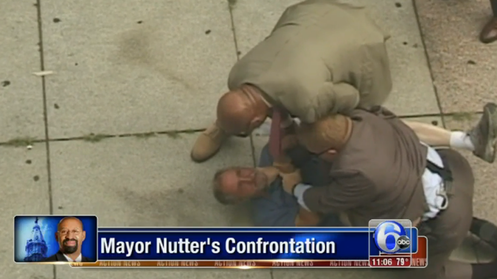 Philadelphia Mayor Michael Nutter helps restrain, calm erratic homeless man