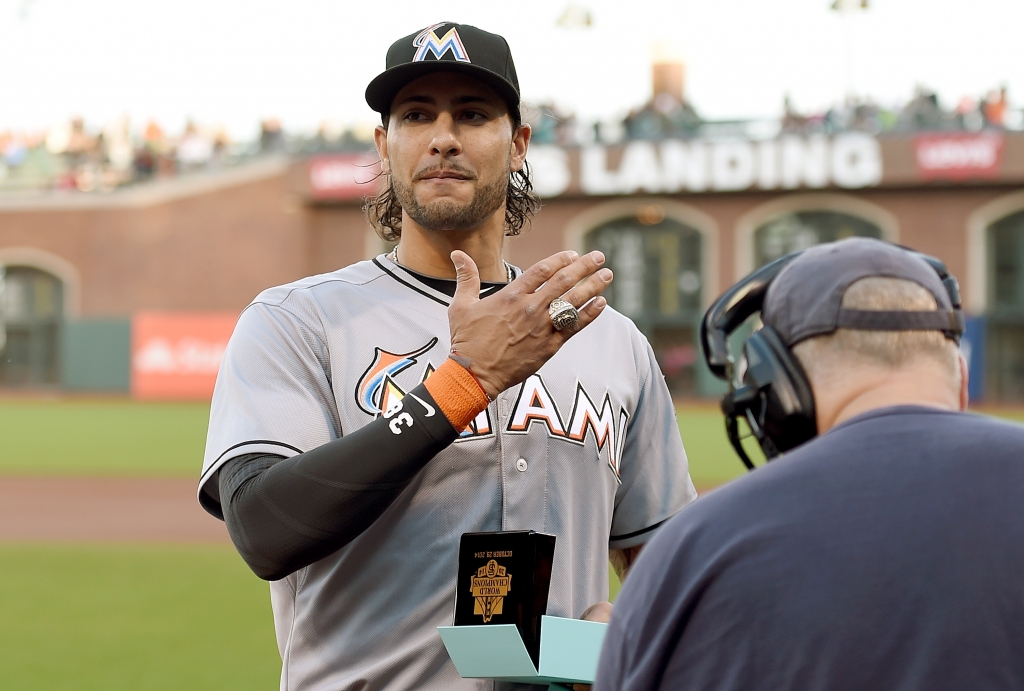 SAN FRANCISCO CA- MAY 07 Michael Morse #38 of the Miami Marlins receiving his 2014 World Series ring from the San Francisco Giants shows it to the fans prior to the start of the game at AT&T Park