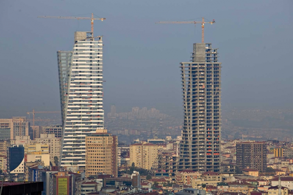 Construction cranes stand above Trump Towers Istanbul in Istanbul Turkey