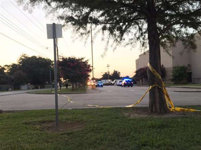 Police tape surrounds the scene following a shooting at a movie theater Thursday