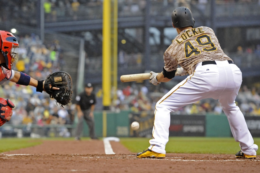 20150709mfbucssports02-1 Pirates starter Jeff Locke lays down a bunt against the Cardinals in the third inning Thursday night at PNC Park