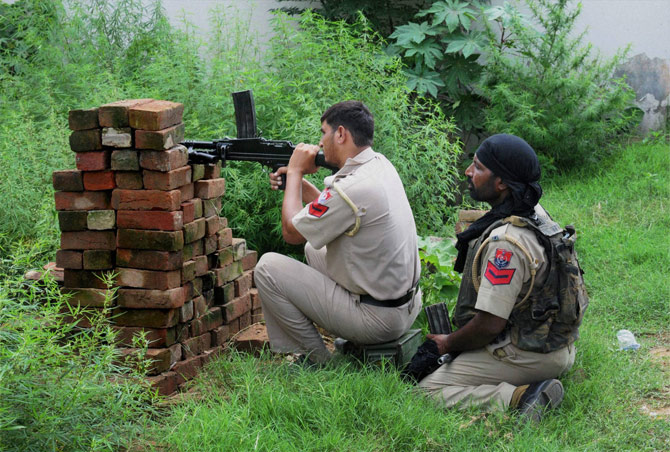 Police personnel during an encounter with militants who attacked a police station at Dinanagar in Gurdaspur district on Monday. Pic  PTI