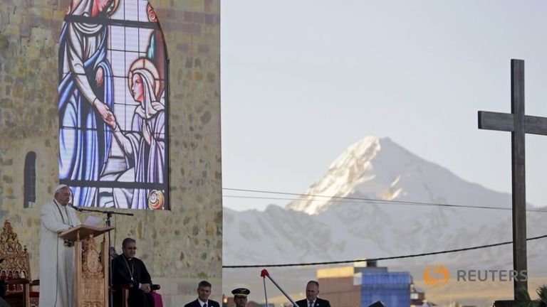 Pope Francis addresses the crowd of faithful as the mountain Illimani is seen in the back in El Alto Bolivia