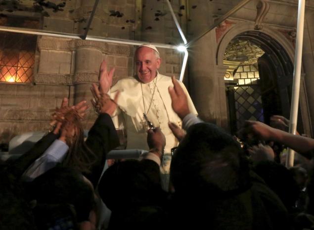 Pope Francis waves to people in Ecuador ahead of his departure to Bolivia Wednesday