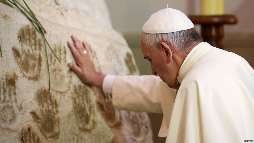 Pope Francis prays in front of the Virgin Mary statue at Caacupe church in Caacupe outside of Asuncion Paraguay