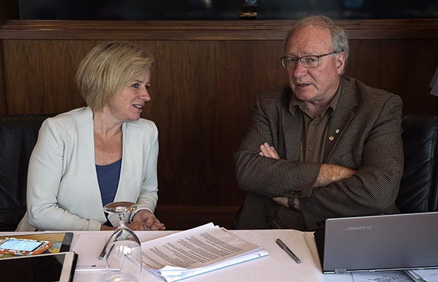 Alberta Premier Rachel Notley left and Prince Edward Island Premier Wade Mac Lauchlan talk during the summer meeting of Canada's premiers in St. John's on Friday