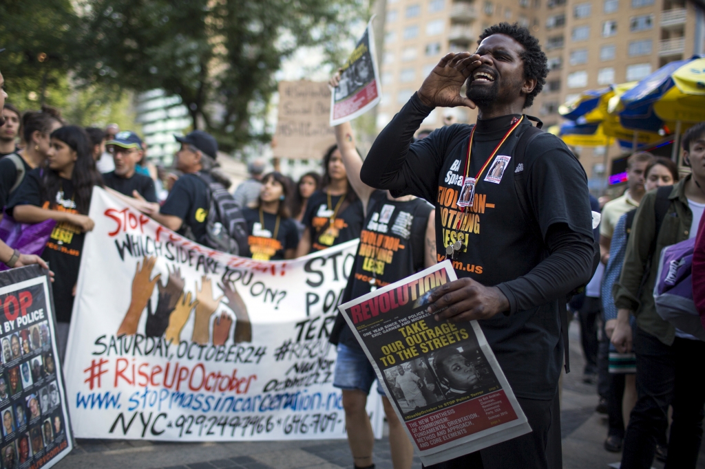 A protester shouts slogans against the New York Police Department during a July 17 rally for Eric Garner who was killed one year ago by police in New York. Family and supporters on Friday marked the anniversary with rallies and vigils