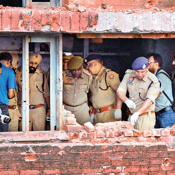 Punjab Police personnel on Tuesday inspect the police station building that was attacked in Dinanagar town of Gurdaspur district on Monday 
    
    AFP