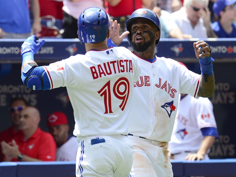 The Toronto Blue Jays&#039 Jose Bautista is congratulated by teammate Jose Reyes after hitting a two-run home run against the Boston Red Sox during second inning American League action in Toronto on Wednesday