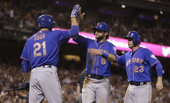 Michael Cuddyer right and Kirk Nieuwenhuis celebrate with Lucas Duda after scoring against the and San Francisco Giants in the ninth inning of a baseball game Monday