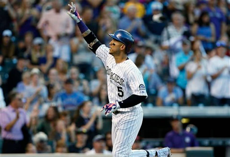 Colorado Rockies&#39 Carlos Gonzalez gestures as he circles the bases after hitting a solo home run off Atlanta Braves starting pitcher Shelby Miller to lead off the fifth inning of a baseball game Friday