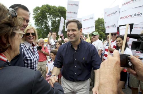 Republican presidential candidate Sen. Marco Rubio R-Fla. shakes hands with Beverly Bruce Romney's New Hampshire finance chairwoman in 2012 as they talk with 2012 GOP presidential nominee Mitt Romney and his wife Ann at the end of the the Fourt