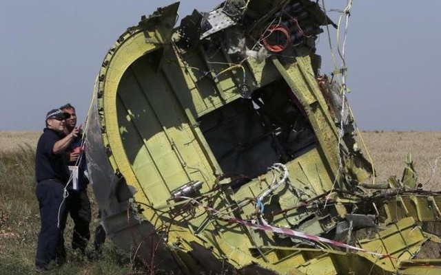 Members of a group of international experts inspect wreckage at the site where the downed Malaysia Airlines flight MH17 crashed near the village of Hrabove in Donetsk region eastern Ukraine