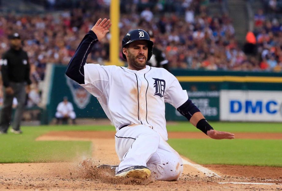 Detroit Tigers J.D. Martinez scores on a single by Jose Iglesias off Chicago White Sox starting pitcher Jose Quintana during the fourth inning of a baseball game Friday