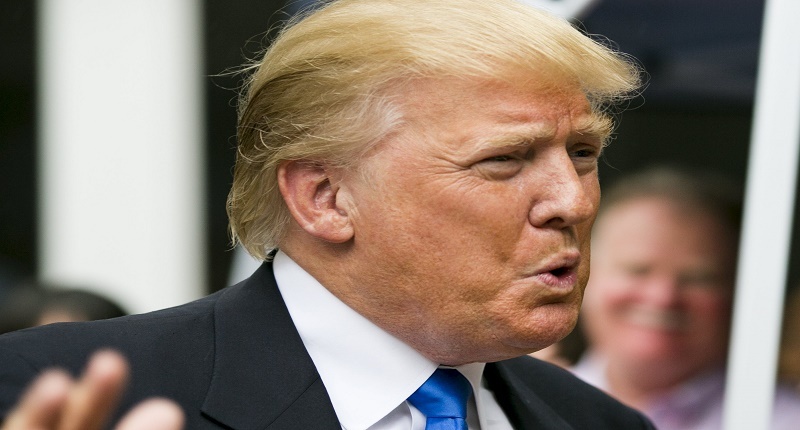 Businessman and Republican presidential candidate Donald Trump reacts to supporters during a back-yard reception in Bedford New Hampshire