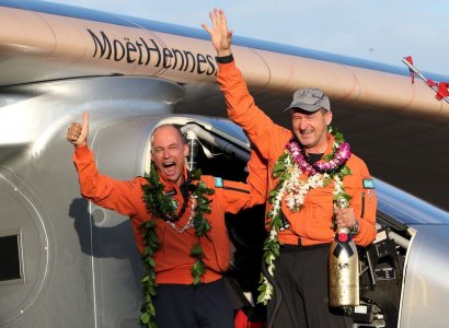 Bertrand Piccard celebrates with Andre Borschberg after the Solar Impulse 2 airplane piloted by Borschberg landed at Kalaeloa airport after flying non-stop from Nagoya Japan in Kapolei Hawaii