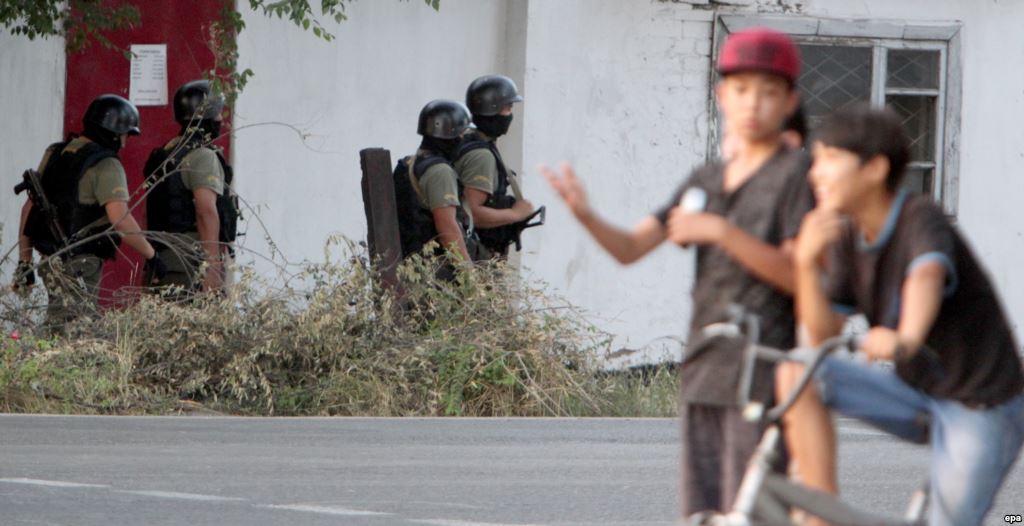 Soldiers secure an area during an antiterrorist operation aimed at eliminating armed militants in a Bishkek neighborhood on July 16