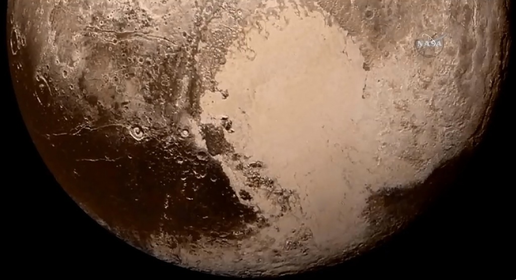 Southern region of Pluto including the heart-shaped Tombaugh Regio. Click to enlarge