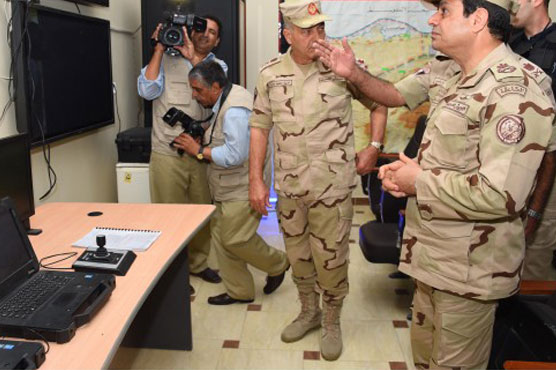 State TV broadcast Sisi dressed in military fatigues touring army base inspecting captured weapons