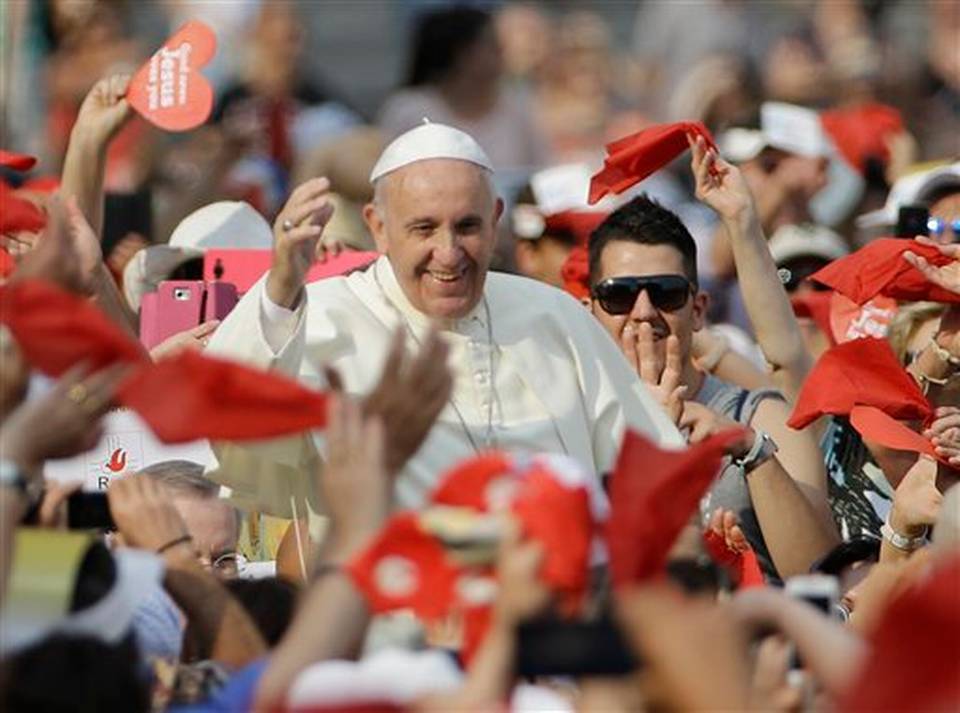 Pope Francis waves as he arrives for a meeting with faithful of the Holy Spirit movement in St. Peter's Square at the Vatican Friday