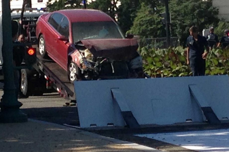 Police say a person is in custody after a vehicle struck a barricade near the U.S. Capitol. Capitol Police say in a statement Friday morning that they'r