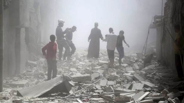 Residents in Aleppo's al Sukkari neighbourhood after an attack by what they said were forces loyal to Syrian President Bashar al Assad earlier this year