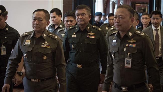 Thai army Lieutenant General Manas Kongpan turns himself in at the police headquarters in Bangkok