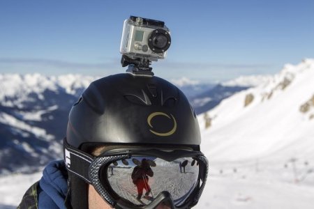 A Go Pro camera is seen on a skier's helmet as he rides down the slopes in the ski resort of Meribel French Alps