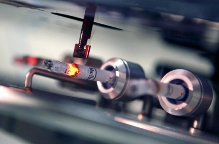 A cigarette smoking robotic tester machine is seen at the Czech Republic-based subsidiary of cigarette-maker Philip Morris International Inc. in Kutna Hora in this