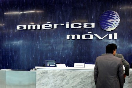 The logo of America Movil is seen on the wall of the reception area in the company's corporate offices in Mexico City