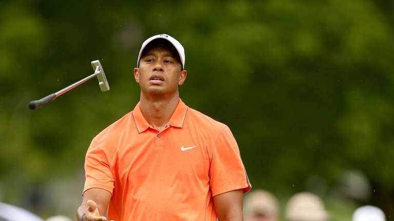 Tiger Woods reacts to a missed birdie putt on the fourth hole