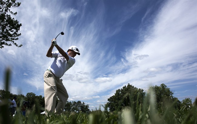 Defending champion Tim Clark from South Africa hits off the 4th tee during the Pro Am at the Canadian Open golf tournament Wednesday