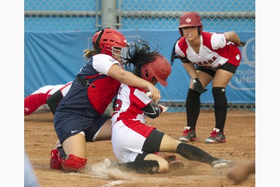 Canada's Jenn Yee is out at home plate as USA's catcher Janelle Lindvall blocks the plate during women's softball action at the Pan Am Games on Saturday night in Ajax