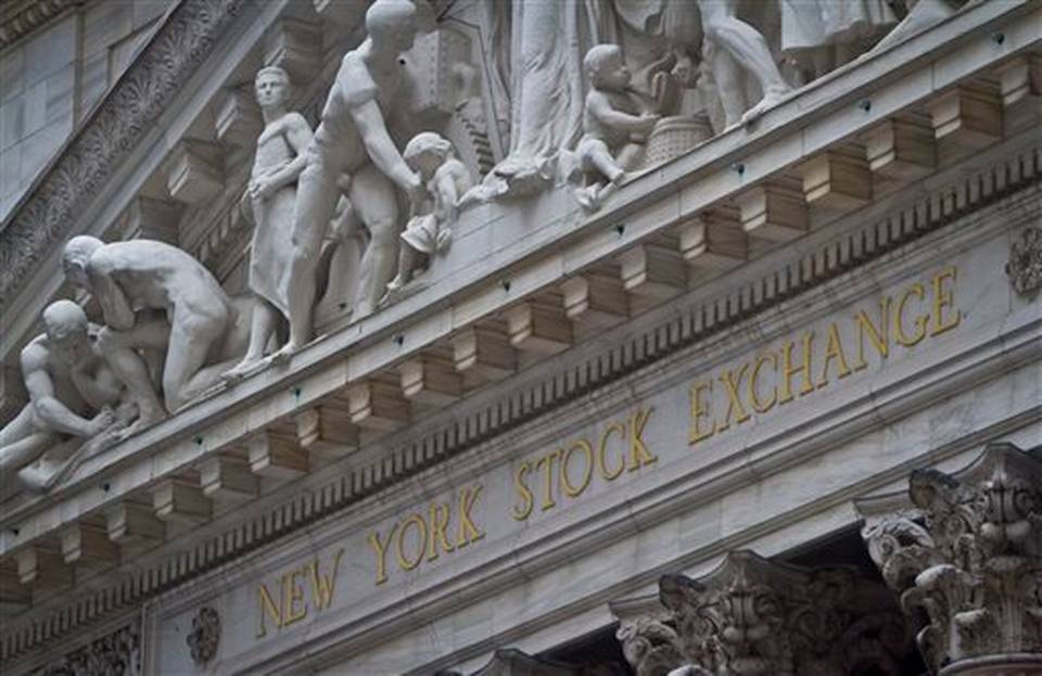 Federal Hall's George Washington statue stands near the flag-covered pillars of the New York Stock Exchange Wednesday