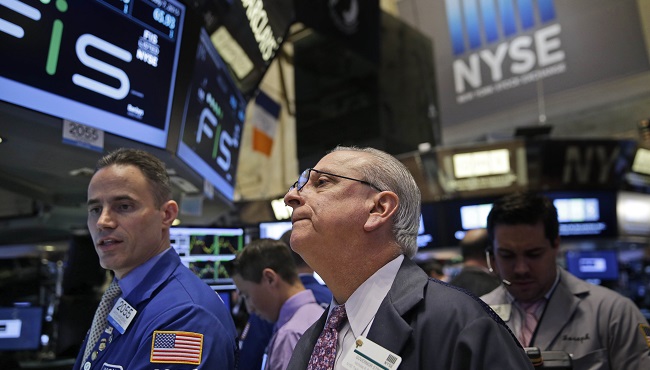 Floor Governor Nicholas Brigandi center works with traders on the floor at the New York Stock Exchange in New York Tuesday