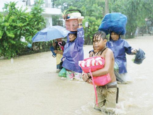 Tropical storm shuts Manila schools floods northern Philippine towns