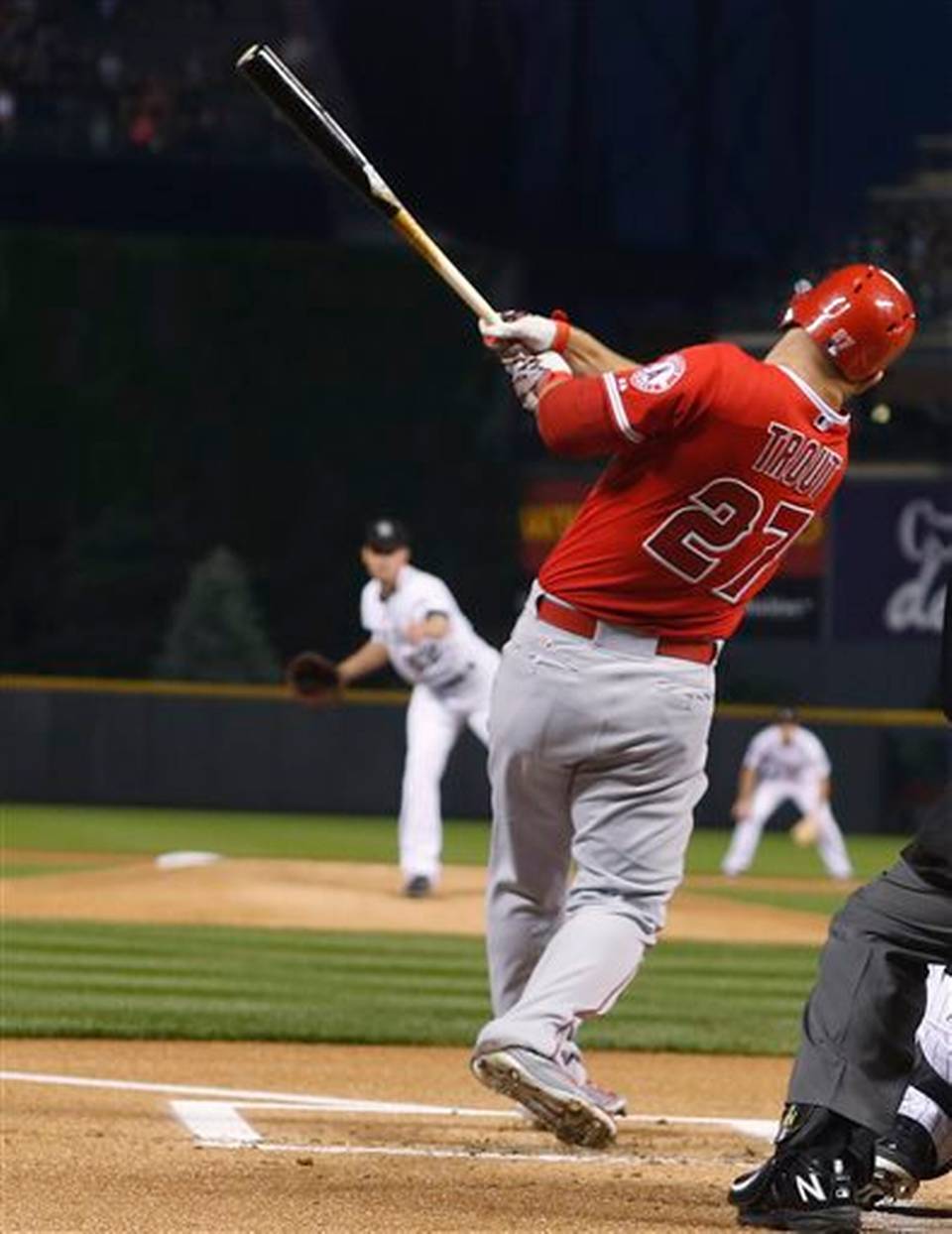 Los Angeles Angels&#39 Mike Trout follows through on a solo home run off Colorado Rockies starting pitcher Chris Rusin during the first inning of a baseball game Wednesday