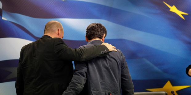 New Greek Finance Minister Euclid Tsakalotos right and outgoing Finance Minister Yanis Varoufakis leave together after a hand-over ceremony in Athens last night