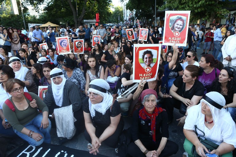 Women hold posters depicting victims of a suicide bombing that killed 32 activists on Monday in the Turkish border town of Suruc during a protest yesterday in Ankara. A suicide bomber identified as a 20-year-old Turk blew himself up on July 20 in the